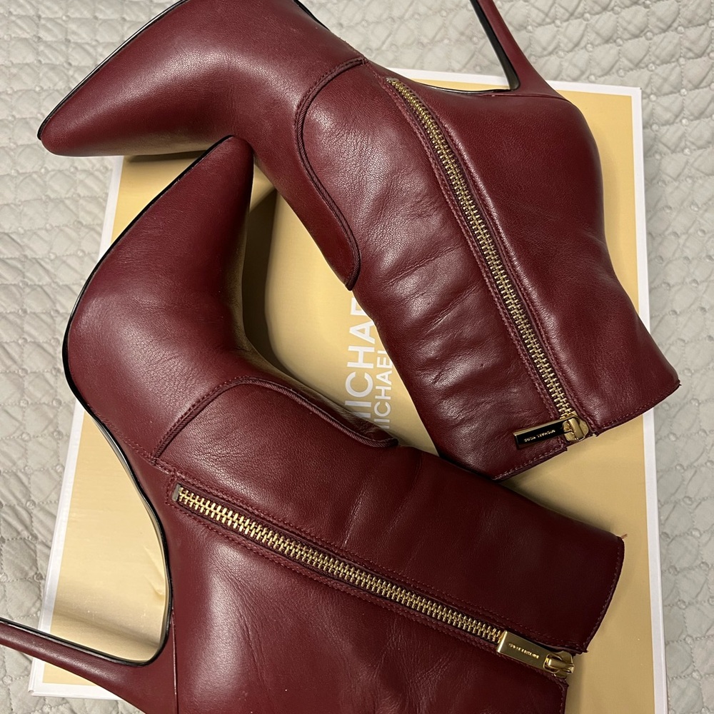 Step into the seasons with these gorgeous ox blood leather MK booties